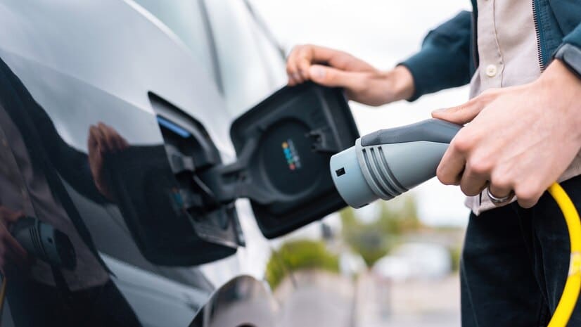 man-opening-cars-charge-socket-holding-charger-charge-station_1268-17735.jpg